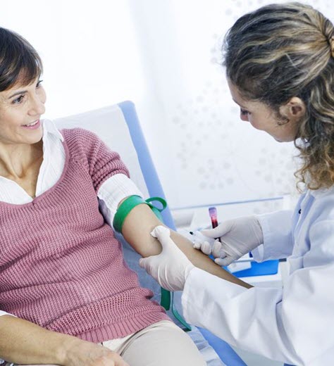Phlebotomist performing a blood draw on a patient